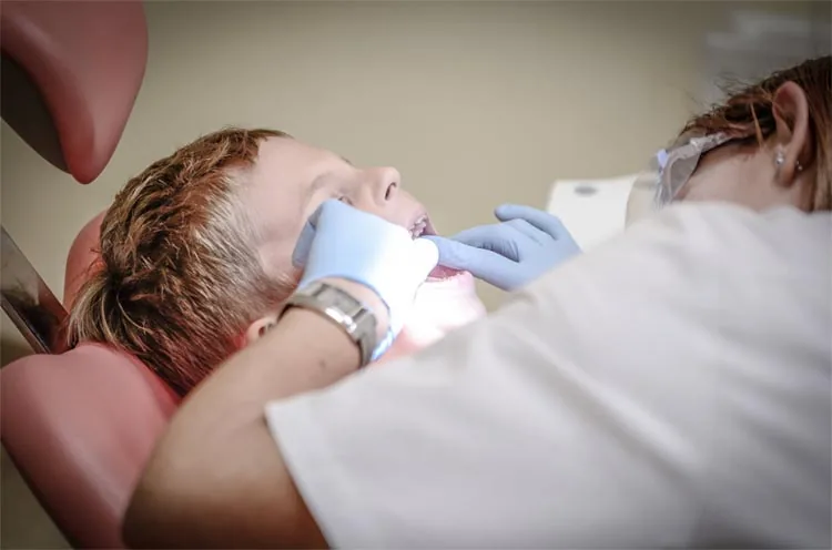 a child receiving dental assistan